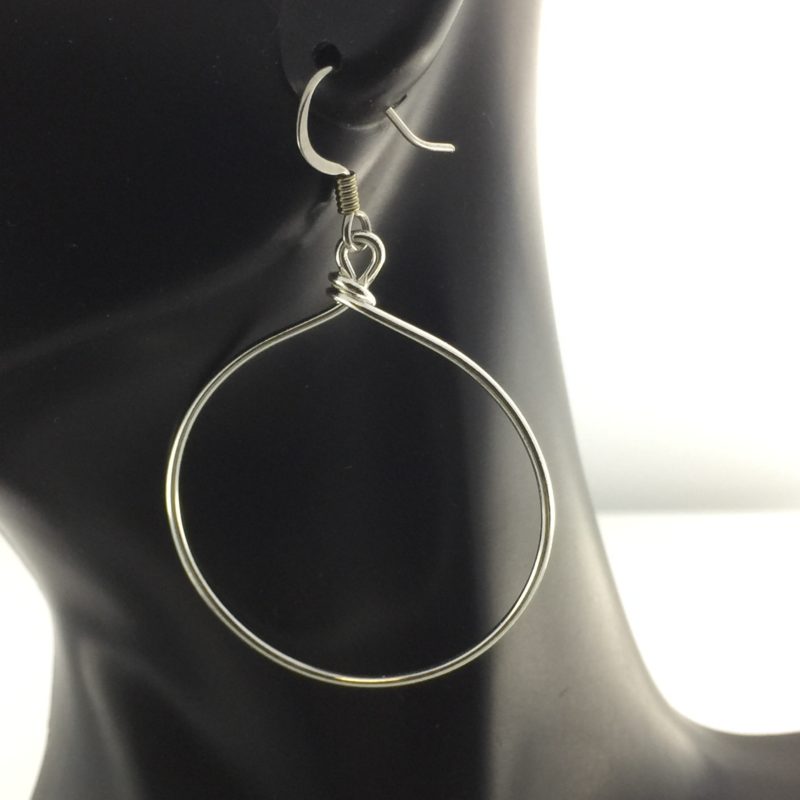 https://sensitively-yours.com/wp-content/uploads/2019/11/JCL077-Large-Silver-Wire-Hoop-on-black.jpg